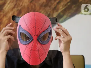 Pekerja memakai face shield atau pelindung wajah karakter Spiderman di Percetakan Bintang Sempurna, Bendungan Hilir, Jakarta, Rabu (24/6/2020). Pelindung wajah karakter tersebut dibanderol dengan harga Rp 35 ribu hingga Rp 50 ribu per buah. (Liputan6.com/Angga Yuniar)