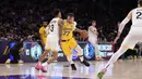 Pemain Los Angeles Lakers, Luka Doncic melakukan dribble melewati pemain Utah Jazz, Keyonte George pada laga lajutan NBA di Crypto.com Arena, Los Angeles, California pada Selasa (11/02/2025) WIB. (AP Photo/Mark J. Terrill)