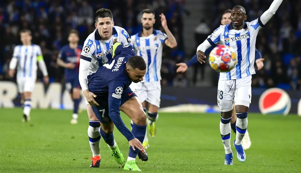 Pemain Real Sociedad, Igor Zubeldia, mengadang pemain Paris Saint-Germain, Kylian Mbappe, pada laga leg kedua babak 16 besar Liga Champions 2023/2024 di Stadion Reale Arena, Rabu (6/3/2024). Berkat hasil ini, PSG pun berhak melaju ke babak perempat final dengan kemenangan agregat 4-1. Pada laga leg pertama di Paris Februari lalu, PSG menang dengan skor 2-0. (AP Photo/Alvaro Barrientos)