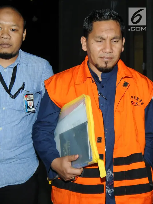 Bupati Bener Meriah Ahmadi dikawal petugas usai menjalani pemeriksaan perdana pasca ditahan OTT di Gedung KPK, Jakarta, Rabu (18/7). Ahmadi diperiksa terkait dugaan suap dana otonomi khusus Aceh tahun anggaran 2018. (Merdeka.com/Dwi Narwoko)