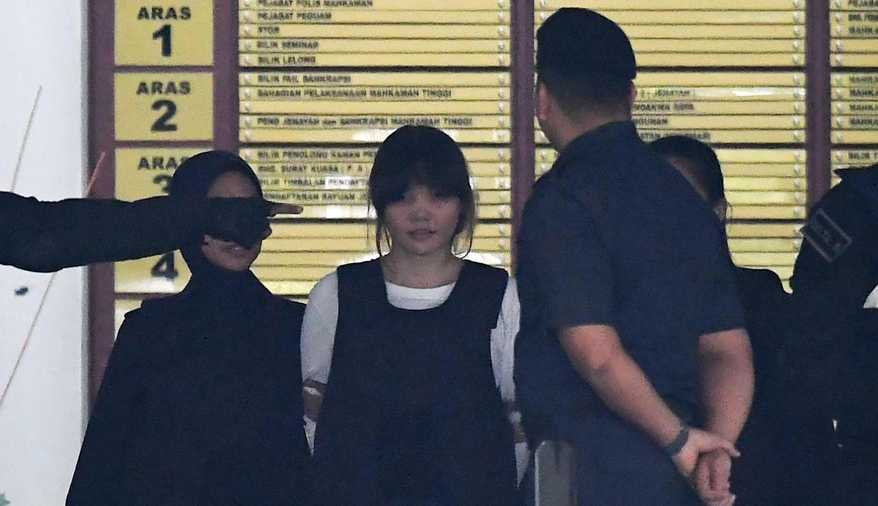 Petugas mengawal tersangka Doan Thi Huong asal Vietnam (kedua kiri) usai menjalani sidang di Pengadilan Tinggi Shah Alam, Kuala Lumpur, Malaysia (2/10). Kim Jong-nam terbunuh dengan racun saraf VX dalam waktu sekitar 20 menit. (AFP Photo/Mohd Rasfan)