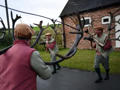 Para penari melakukan 'Abbots Bromley Horn Dance' di desa Abbots Bromley, Inggris (11/9). Tarian ini dibawakan oleh enam orang dengan menggunakan tanduk rusa kutub yang berasal dari abad ke-11 atau sudah berusia 1000 tahun. (AFP Photo/Oli Scarff)
