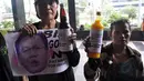 Massa BRSK juga membawa botol jamu yang bertuliskan 'Jamu Kuat Lawan Koruptor BLBI", Jakarta, Selasa (26/8/14). (Liputan6.com/Miftahul Hayat) 