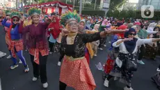 Para perempuan dari segala umur menggelar Flashmob Poco-poco Berkebaya bersama kelompok perempuan lainnya di Bundaran HI, Jakarta, Minggu (14/7/2024). (Liputan6.com/Herman Zakharia)