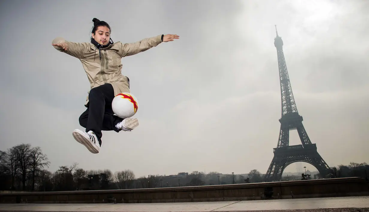 Aksi Andreas bermain bersama bola di Place du Trocadero, dengan  latar menara Effeil, Paris, Jumat (18/3/2016).  S3 Society akan tampil pada Euro 2016 Pracis tanggal 10 Juni-10 Juli 2016. (AFP/Lionel Bonaventure)