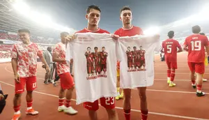 Dua pemain Timnas Indonesia, Justin Hubner (kiri) dan Ivar Jenner memegang jersey pemberian fans bergambar foto keduanya bersama rekannya, mendiang Noah Gesser setelah berakhirnya laga Grup F putaran kedua Kualifikasi Piala Dunia 2026 zona Asia menghadapi Irak di Stadion Utama Gelora Bung Karno (SUGBK), Senayan, Jakarta, Kamis (6/6/2024). (Bola.com/M Iqbal Ichsan)