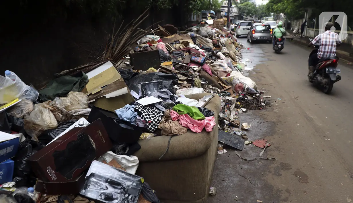 Tumpukan sampah terlihat menumpuk di sepanjang jalan pascabanjir mulai surut di kawasan Kembangan, Jakarta Barat, Minggu (5/1/2020). Pasca banjir yang melanda hampir di kawasan Jakarta mulai surut, tumpukan sampah terlihat di sepanjang jalan dari rumah-rumah warga. (Liputan6.com/Johan Tallo)