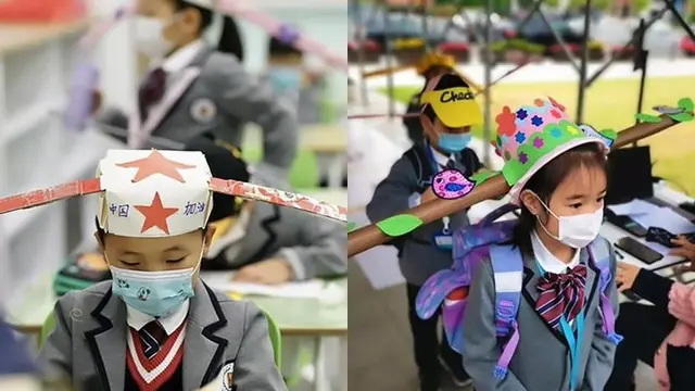 Terapkan Physical Distancing, Murid di China Ini Kenakan Topi Anti Corona