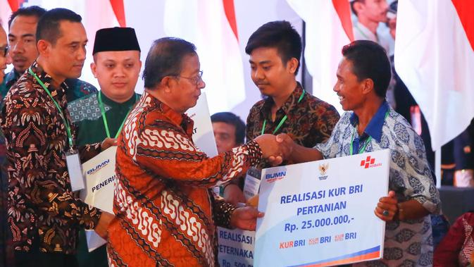 Menteri Koordinator Bidang Perekonomian RI Darmin Nasution (tengah) menyerahkan KUR BRI sektor pertanian senilai total Rp 525 juta kepada dua petani secara simbolis