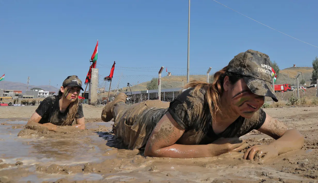 Perwira wanita Peshmerga melakukan latihan saat mengambil bagian dalam upacara kelulusan di Kota Soran, Irak, Rabu (16/10/2019). Latihan pasukan bersenjata Kurdi tersebut dilakukan sekitar 100 kilometer timur laut ibu kota otonomi wilayah Kurdi di Irak, Arbil. (SAFIN HAMED/AFP)