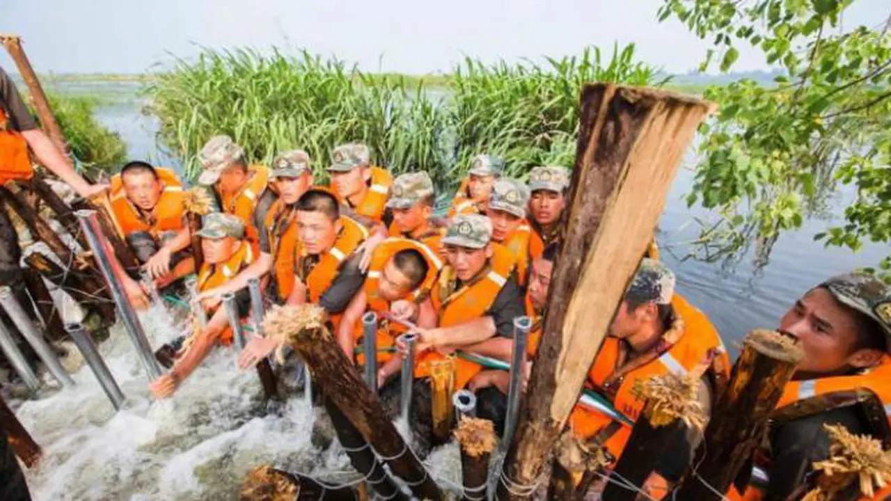 'Pasang Badan,' Para Tentara Cina Ini Ramai-ramai Cegah Banjir