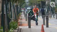 Seorang pria mengendarai skuter listrik di trotoar Jakarta, Jumat (22/11/2019). Tidak ada sanksi dari Pemprov DKI Jakarta terhadap pengguna skuter listrik selama regulasi yang mengatur masih dalam pembahasan. (merdeka.com/Imam Buhori)