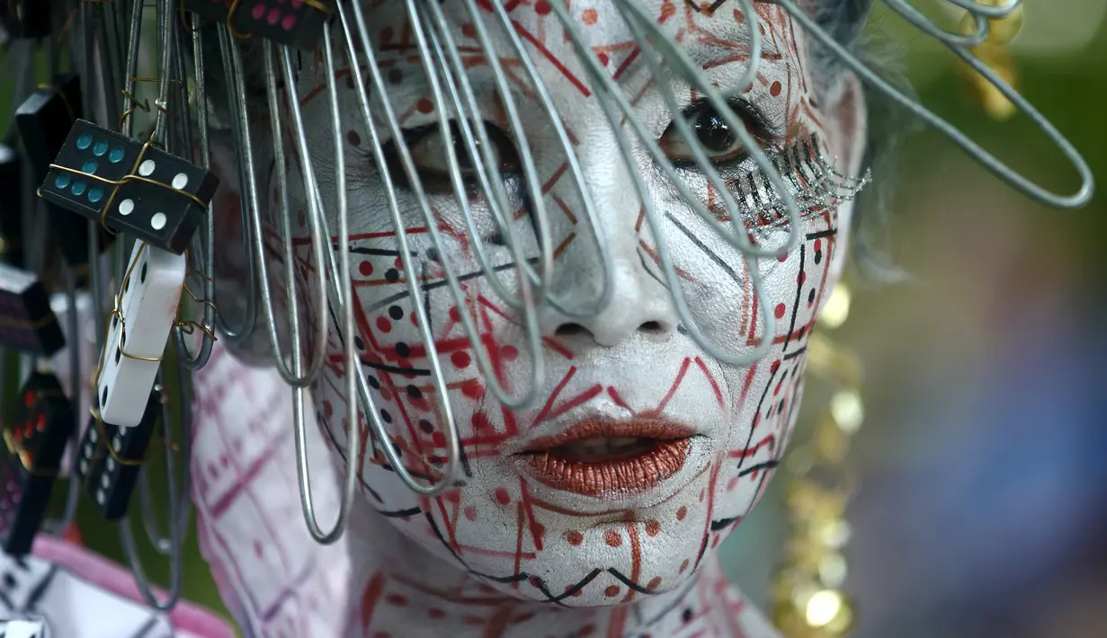 Ekspresi model mengenakan aksesoris unik di kepalanya saat mengikuti Festival Bodypainting Dunia 2015 di Poertschach, Austria, (3/7/2015). Festival ini digelar di Danau Woerthersee, dari tanggal 3-5 Juli. (Reuters/Heinz-Peter Bade)