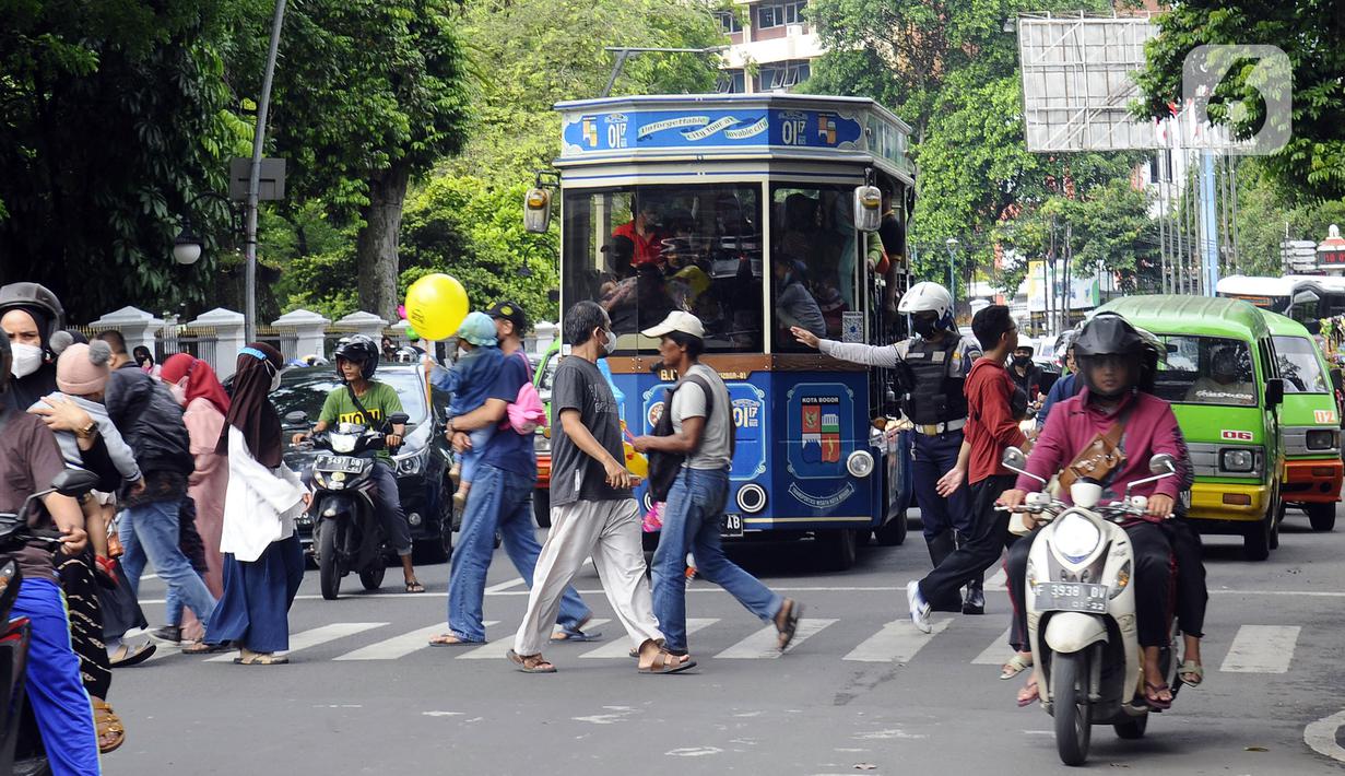 Bus wisata Uncal melintas di depan Balai Kota Bogor, Bogor, Jawa Barat, Minggu (29/5/2022). Bus wisata gratis yang disediakan untuk mengelilingi kawasan Kebun Raya Bogor setiap hari Sabtu dan Minggu ini mulai beroperasi kembali pascapandemi. (merdeka.com/Arie Basuki)
