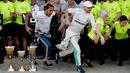 Pembalap Mercedes Lewis Hamilton dan rekan setimnya Valtteri Bottas berlari usai memenangkan F1 GP Rusia di Sochi Autodrom, Sochi, Minggu (29/9/2019). Hamilton dan Bottas finis di posisi pertama dan kedua. (AP Photo/Luca Bruno)