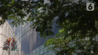 Pekerja membersihkan kaca gedung bertingkat di Jakarta, Kamis (2/4/2020). Keluarnya Peraturan Pemerintah (PP) Nomor 82 Tahun 2019 yang resmi berlaku pada 2 Desember 2019 diharapkan dapat meningkatkan jumlah perusahaan dan pekerja peserta skema BP Jamsostek. (Liputan6.com/Herman Zakharia)
