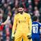 Kiper Liverpool, Alisson Becker, tampak kecewa setelah ditaklukkan PSG lewat adu penalti 0-1 (1-4) dalam laga leg kedua 16 besar Liga Champions 2024/2025 yang digelar di Anfield, Rabu (12/3/2025) dini hari WIB. (AFP/Oli Scarff)