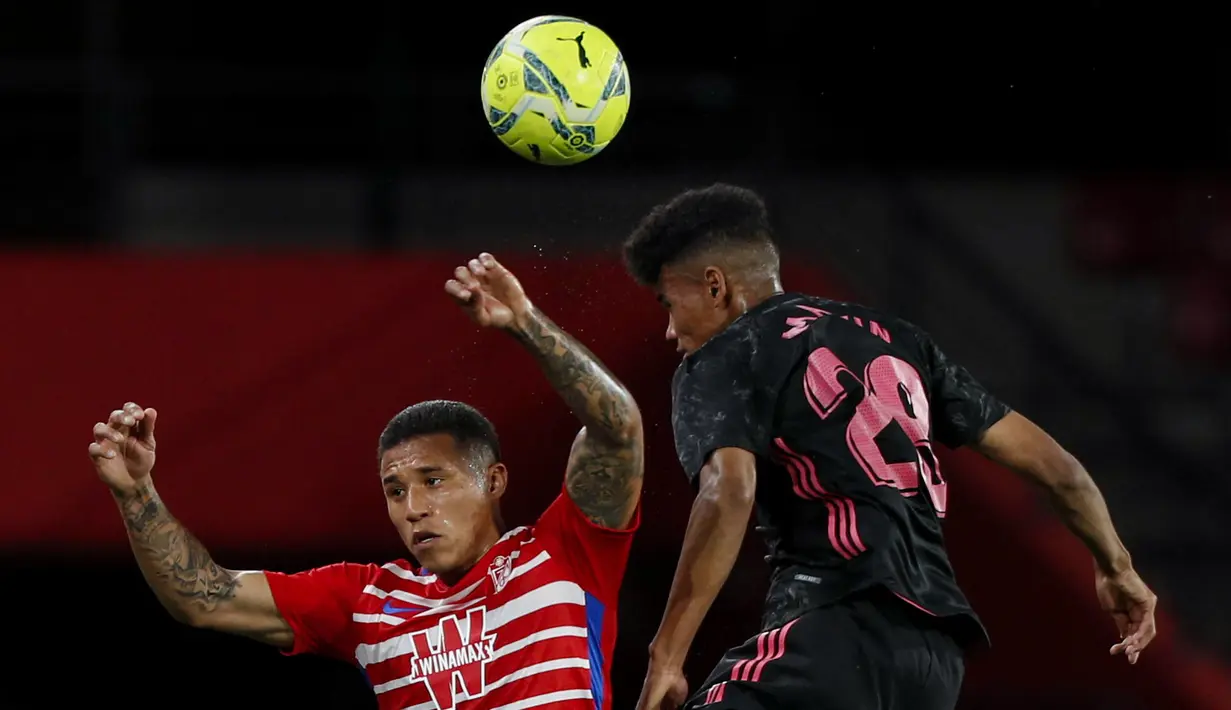 Striker Granada, Darwin Machis (kiri) berduel udara dengan gelandang Real Madrid, Marvin Park dalam laga lanjutan Liga Spanyol 2020/2021 pekan ke-36 di Los Carmenes Stadium, Granada, Kamis (13/5/2021). Granada kalah 1-4 dari Real Madrid. (AP/Fermin Rodriguez)