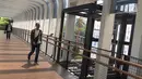 Pejalan kaki melintas di dekat pembangunan lift pada jembatan penyeberangan orang di Jakarta, Senin (13/5). Pembangunan lift pada tiga JPO yang berada di Jalan Sudirman itu bertujuan meningkatkan kenyamanan kepada warga dan ditargetkan rampung akhir bulan ini.(Liputan6.com/Immanuel Antonius)