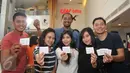 Sejumlah peserta menunjukan tiket yang telah disediakan panitia di CGV Blitz, Bandung, Minggu (7/8). Cinemaholic dan Panasonic Vierra gelar nonton bareng Rebel's Team. (Liputan6.com/Gempu M Surya)