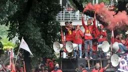 Buruh menyalakan flare saat aksi Hari Buruh di Jalan Medan Merdeka, Jakarta, Senin (5/1). Minta diperbolehkan mendekat ke Istana Negara, buruh menyalakan kembang api dan flare. (Liputan6.com/Yoppy Renato)