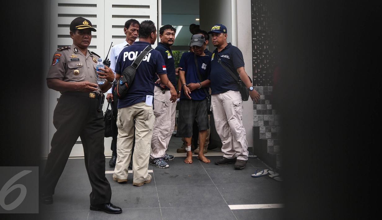 Tersangka Ridwan Sitorus alias Ius Pane menjalani prarekonstruksi kasus perampokan dan pembunuhan di perumahan Pulomas, Jakarta Timur, Jumat (6/1). Sebanyak 71 adegan dilakukan untuk kelengkapan pemeriksaan. (Liputan6.com/Faizal Fanani)