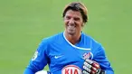 A picture taken on July 8, 2008 in Madrid, Spain shows Atletico Madrid's new 35-year-old goalkeeper Gregory Coupet smiling as he poses with his new jersey/ PIERRE-PHILIPPE MARCOU