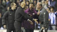 Pelatih Manchester City, osep Guardiola (2kiri) terlibat adu mulut dengan pelatih Wigan, Paul Cook pada laga babak kelima Piala FA di DW Stadium, Wigan, (19/2/2018). Manchester City kalah 0-1.  (AP/Rui Vieira)