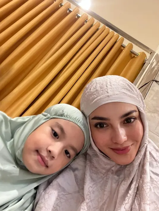 <p>Ririn Ekawati memamerkan potret selfie gemasnya bersama anak perempuan keduanya, mengenakan mukena. Ririn mengenakan mukena berwarna cokelat dengan bordir cantik, sedangkan sang anak memilih mukena hijau pastel yang polos. [Foto: Instagram/ririnekawati]</p>