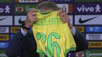 Carlo Ancelotti memegang jersey bertuliskan dirinya saat acara perkenalan pelatih baru Timnas Brasil di sebuah hotel di Barra da Tijuca, Rio De Janeiro, Brasil, Senin (26/05/2025) waktu setempat. (AP Photo/Silvia Izquierdo)