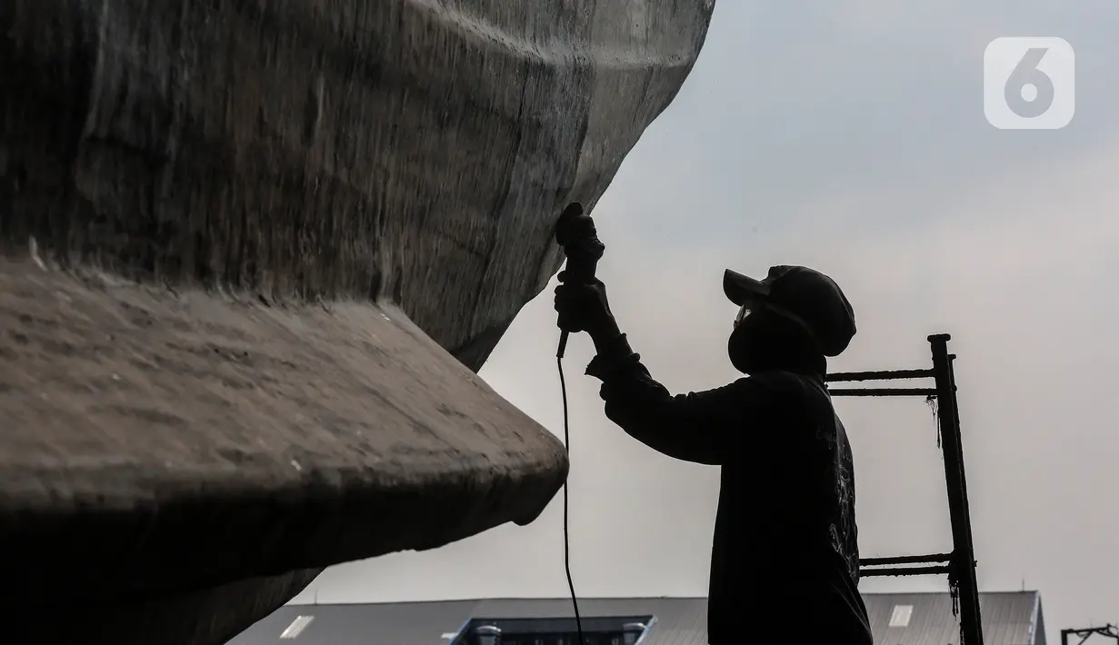 Aktivitas pekerja saat memperbaiki kapal di sebuah galangan kapal kawasan Muara Angke, Jakarta Utara, Kamis (3/6/2021). Banyaknya aktivitas dengan transportasi laut di pesisir utara Jakarta membuka peluang usaha perbaikan dan perawatan kapal laut. (Liputan6.com/Johan Tallo)