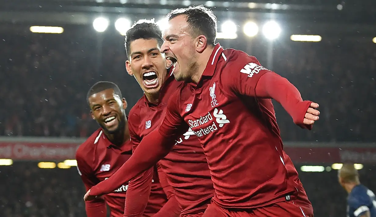 Gelandang Liverpool, Xherdan Shaqiri, merayakan gol yang dicetaknya ke gawang Mnachester United pada laga Premier League di Stadion Anfield, Liverpool, Minggu (16/12). Liverpool menang 3-1 atas MU. (AFP/Paul Ellis)