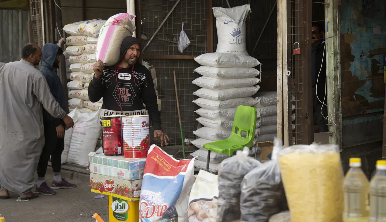 Aktivitas bongkar muat bahan makanan di pasar Jamila Baghdad, Irak, Rabu, 9 Maret 2022. Harga makanan, bahan bakar, dan bahan konstruksi naik 20 hingga 50 persen di Irak, karena situasi perang saat ini di Ukraina. (AP Photo/Hadi Mizban)