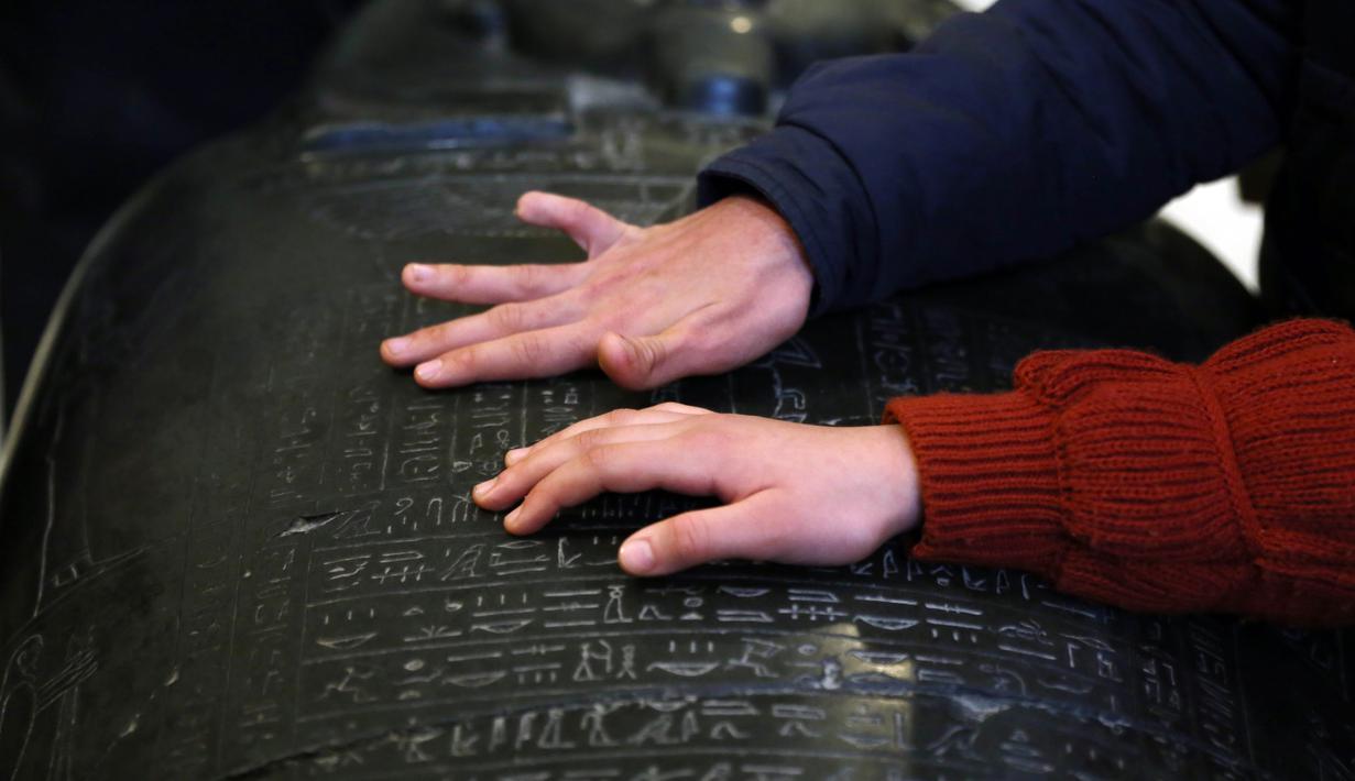 Anak-anak penyandang tunanetra menyentuh sebuah artefak di Museum Mesir di Kairo, Mesir (13/1/2020). Pada tanggal 28 Januari 2011 saat Revolusi Mesir 2011, museum ini didobrak oleh ratusan orang dan dua mumi dilaporkan hancur.  (Xinhua/Ahmed Gomaa)