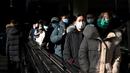 Orang-orang menggunakan eskalator di stasiun kereta bawah tanah di Beijing, Kamis (27/1/2022). Tahun Baru Imlek 2022 yang jatuh pada 1 Februari mendatang akan jadi tahun shio macan. (AFP/Noel Celis)