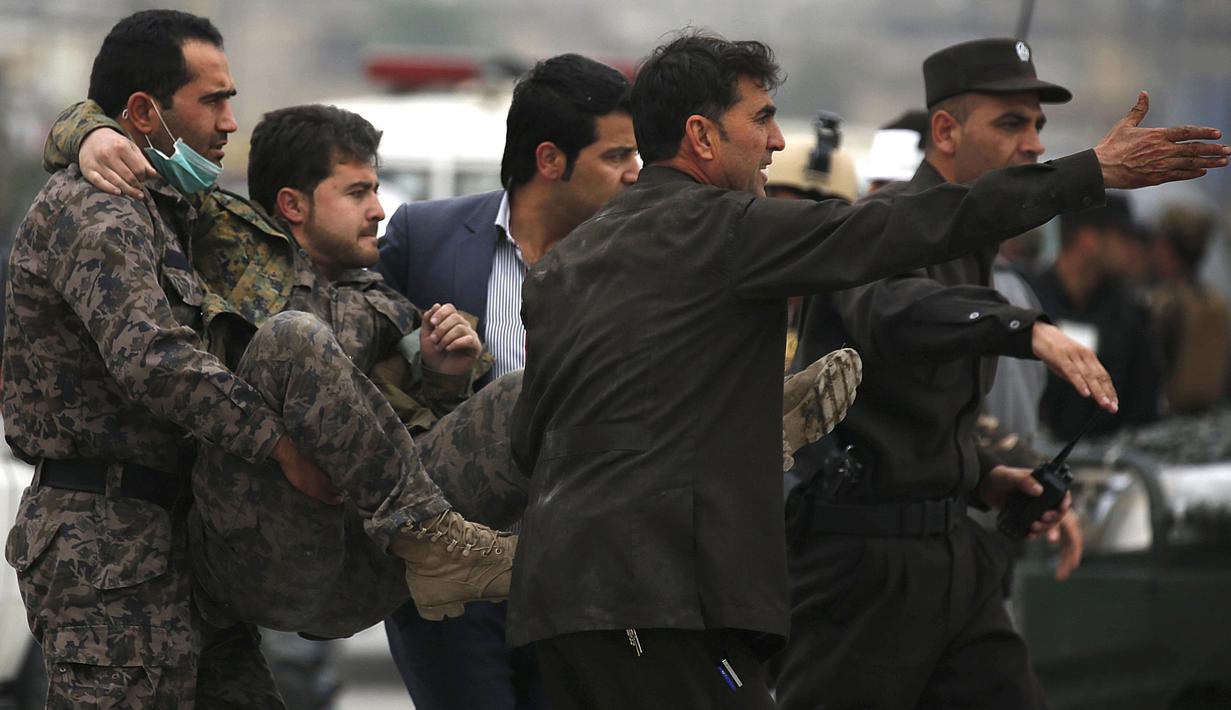 Pasukan keamanan Afghanistan membawa petugas yang terluka setelah ledakan bom bunuh diri di Kabul, Selasa (19/4). Belum ada pihak yang mengklaim soal siapa di balik serangan ini. Tetapi dugaan terkuat tertuju pada kelompok Taliban. (REUTERS/Omar Sobhani)