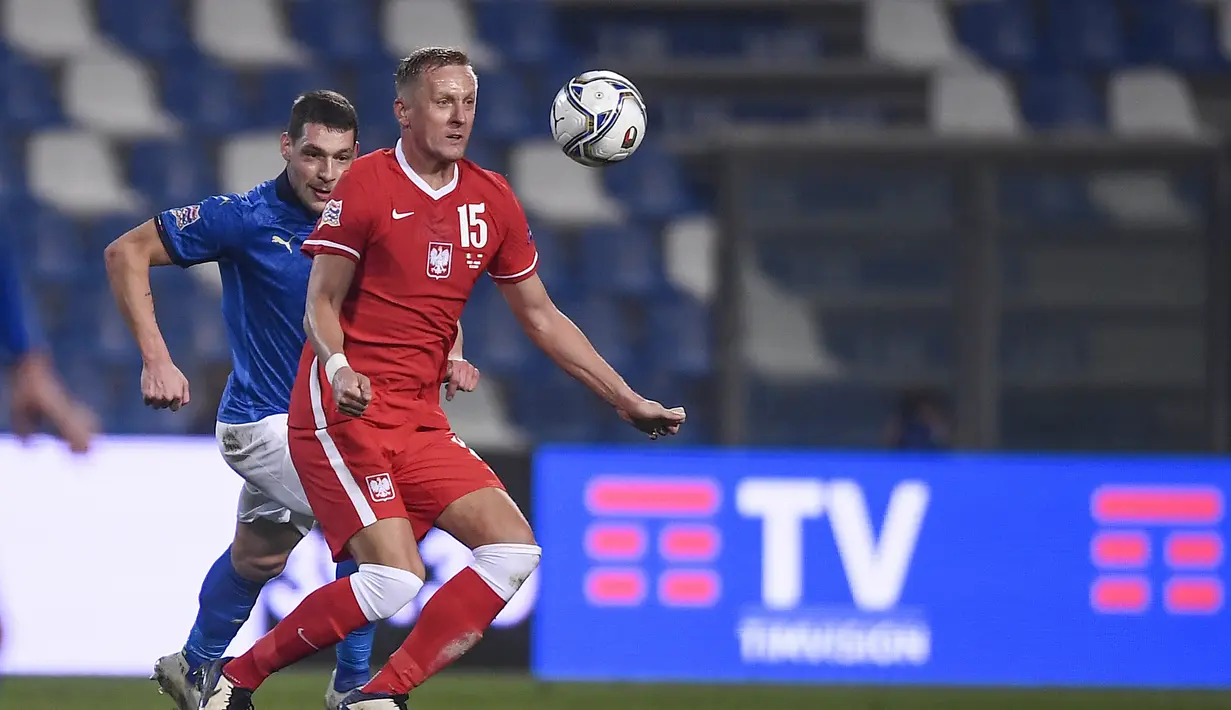 Pemain Polandia, Kamil Glik berusaha mengontrol bola dari kawalan pemain Italia, Andrea Belotti pada pertandingan UEFA Nations League di Stadion Mapei, di Reggio Emilia, Italia, Minggu (15/11/2020). Italia menang atas Polandia 2-0. (Fabio Ferrari/LaPresse via AP)