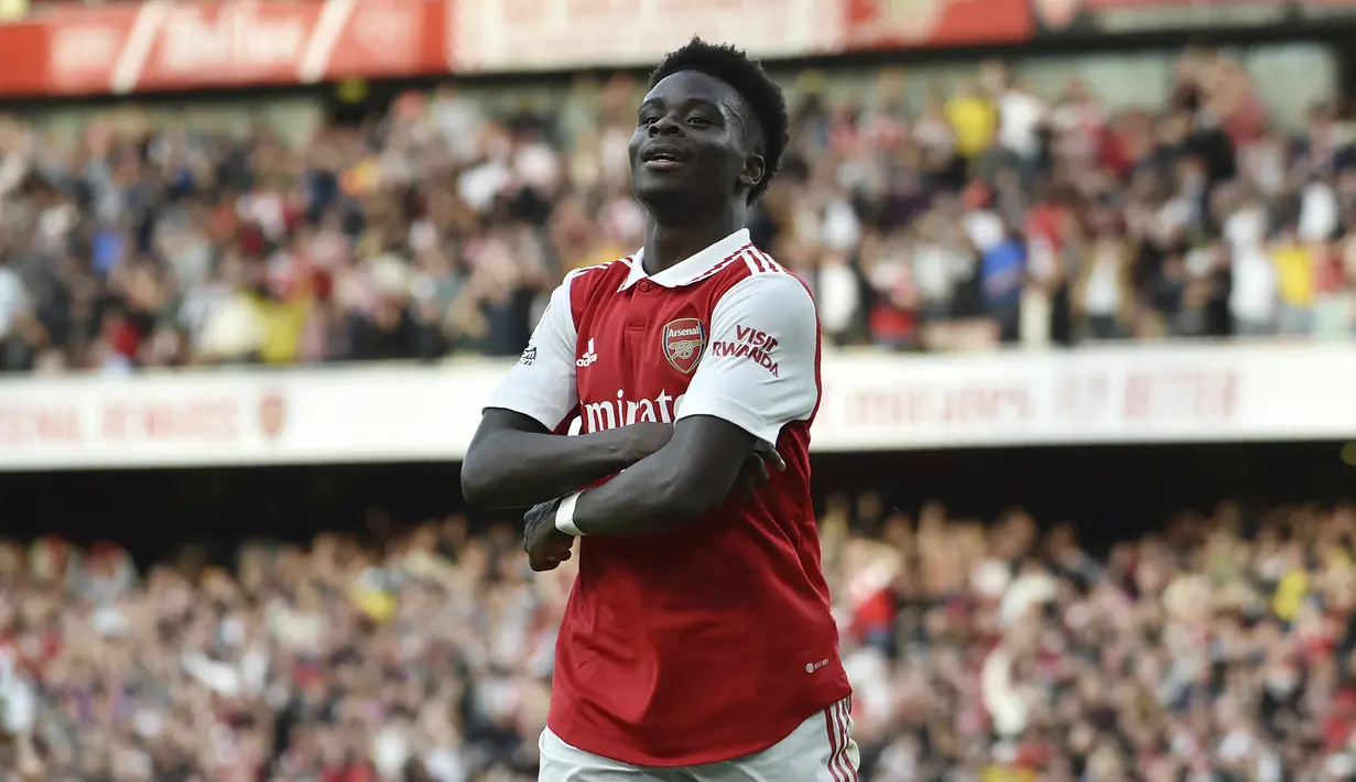 Gelandang Arsenal, Bukayo Saka berselebrasi usai mencetak gol ke gawang Liverpool pada pertandingan lanjutan Liga Inggris di Stadion Emirates di London, Minggu (9/10/2022). Saka mencetak dua gol dan mengantar Arsenal menang tipis atas Liverpool dengan skor 3-2. (AP Photo/Rui Vieira)