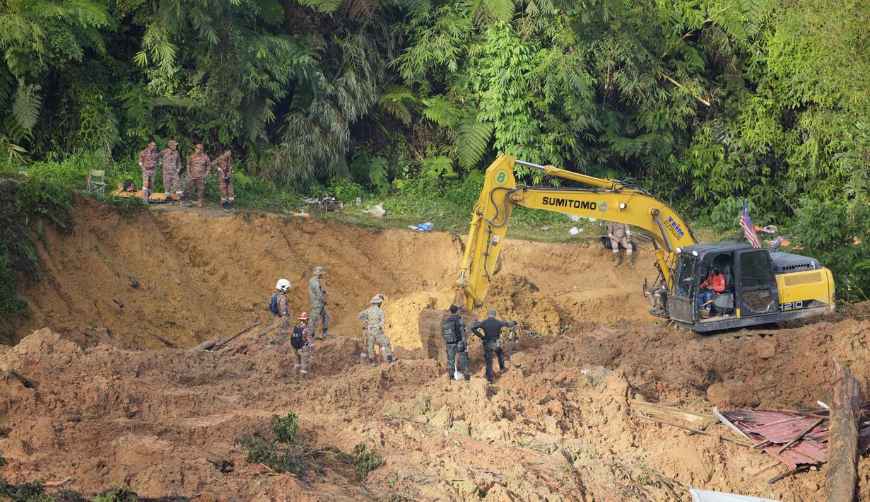 Tim penyelamat menggunakan alat berat melanjutkan pencarian korban yang terjebak dalam tanah longsor di Batang Kali, Malaysia, Sabtu, 17 Desember 2022. Longsor Jumat, 16 Desember 2022, di sebuah perkemahan wisata di Malaysia menyebabkan lebih dari selusin orang tewas dan pihak berwenang mengatakan belasan orang lainnya dikhawatirkan terkubur di lokasi di sebuah pertanian organik di luar ibu kota Kuala Lumpur. (AP Photo/Vincent Thian)