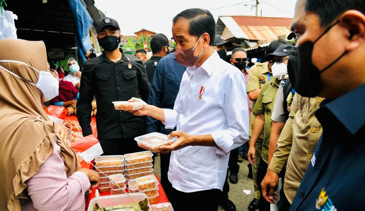 Presiden Joko Widodo (Jokowi) membagikan bantuan langsung tunai (BLT) kepada para pedagang di Pasar Baru Tanjung Enim, Sumatra Selatan, Senin (24/1/2022). Bantuan sebesar Rp1,2 juta per orang itu diberikan Jokowi dengan ditemani Menteri BUMN Erick Thohir. (Dok. Biro Pers Kepresidenan)