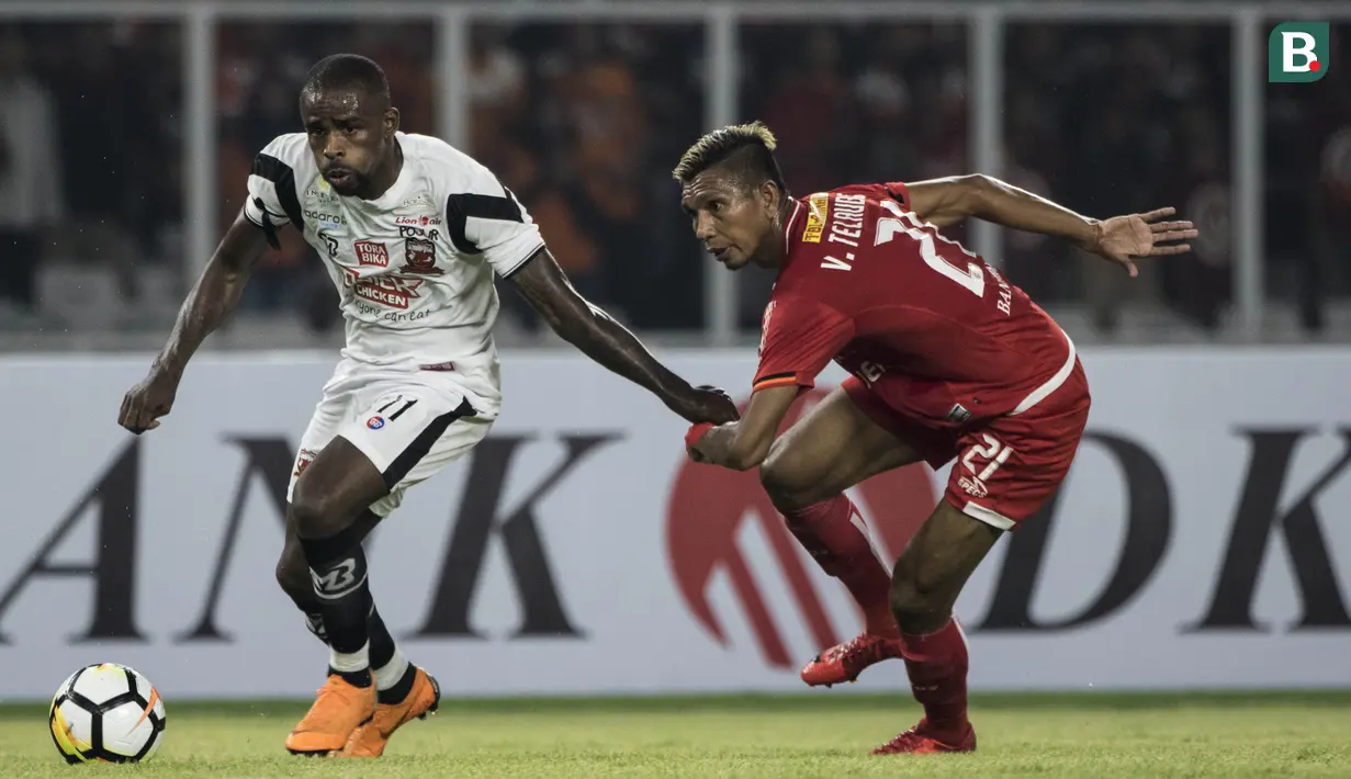 Striker Madura United, Greg Nwokolo, berusaha melewati bek Persija Jakarta, Valentino Telaubun, pada laga Liga 1 di SUGBK, Jakarta, Sabtu (12/5/2018). Persija kalah 0-2 dari Madura United. (Bola.com/Vitalis Yogi Trisna)