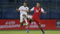 Pemain Persija Jakarta, Yann Motta Pinto (kanan), berebut bola dengan pemain PSM Makassar, Yakob Sayuri, dalam pertandingan Babak Penyisihan Piala Menpora 2021 di Stadion Kanjuruhan, Malang. Senin (22/3/2021). (Bola.com/Arief Bagus)