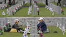 Sepasang suami istri duduk di depan nisan saudara lelakinya, Song Hyun-won, yang gugur untuk negara pada Memorial Day di Pemakaman Nasional Seoul, Kamis (6/6/2019). Memorial Day didedikasikan untuk mengingat prajurit dan warga sipil yang gugur selama perang Korea antara 1950-1953 (AP/Ahn Young-joon)
