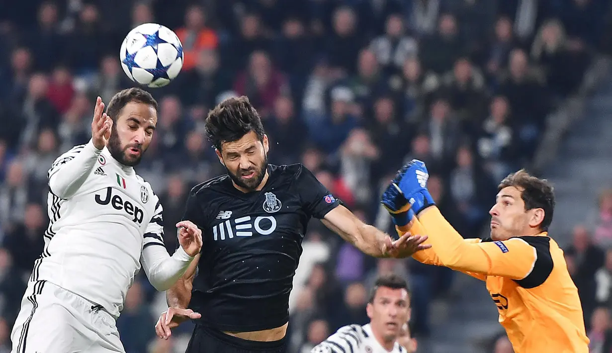 Pemain Juventus, Gonzalo Higuain (kiri) berduel dengan pemain Porto, Felipe  dan kiper Iker Casillas pada Babak 16 Besar Liga Champions di Juventus Stadium, (14/3/2017). Juventus menang 1-0. ((EPA/Alessandro Di Marco)