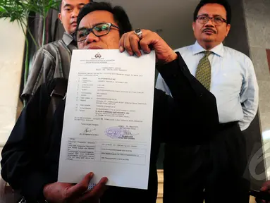 Kuasa hukum Bambang Soesatyo memperlihatkan surat tanda bukti lapor di Mabes Polri, Jakarta, Senin (30/3/2015). Ali Syamiarta melaporkan Agus Gumiwang karena dianggap telah memalsukan dokumen milik Partai Golkar.(Liputan6.com/Yoppy Renato) 