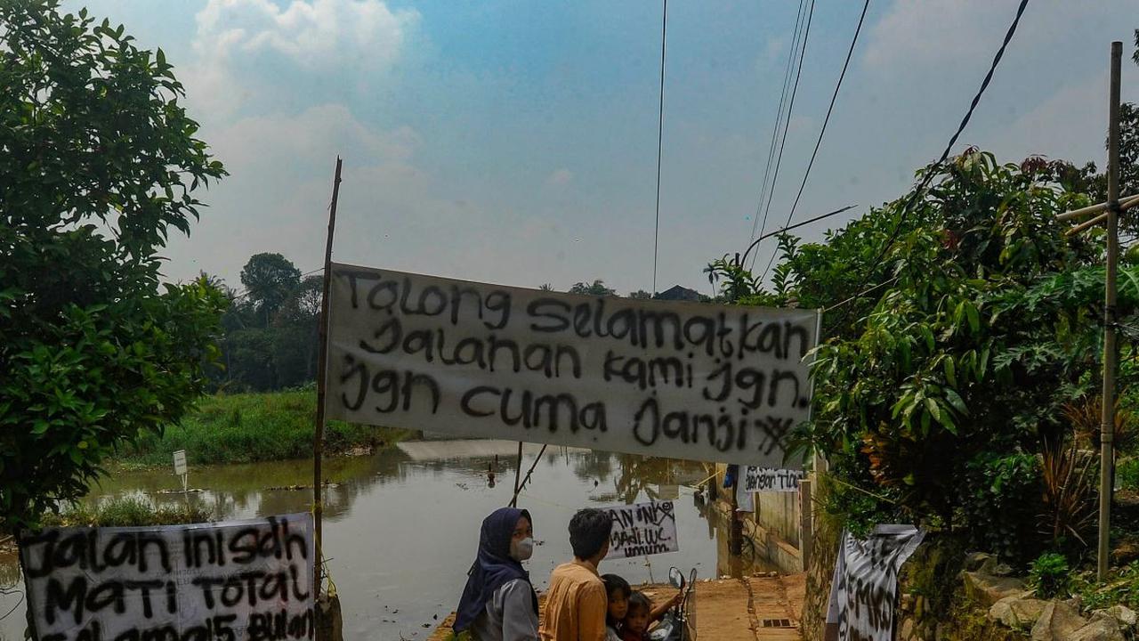 Warga memutar sepeda motornya ketika banjir akibat longsor TPA Cipayung merendam jalanan di Depok, Jawa Barat, Selasa (30/4/2024). Sudah lebih dari satu tahun, sampah di TPA Cipayung yang overload longsor dan menimbun sebagian badan Kali Pesanggrahan.&nbs