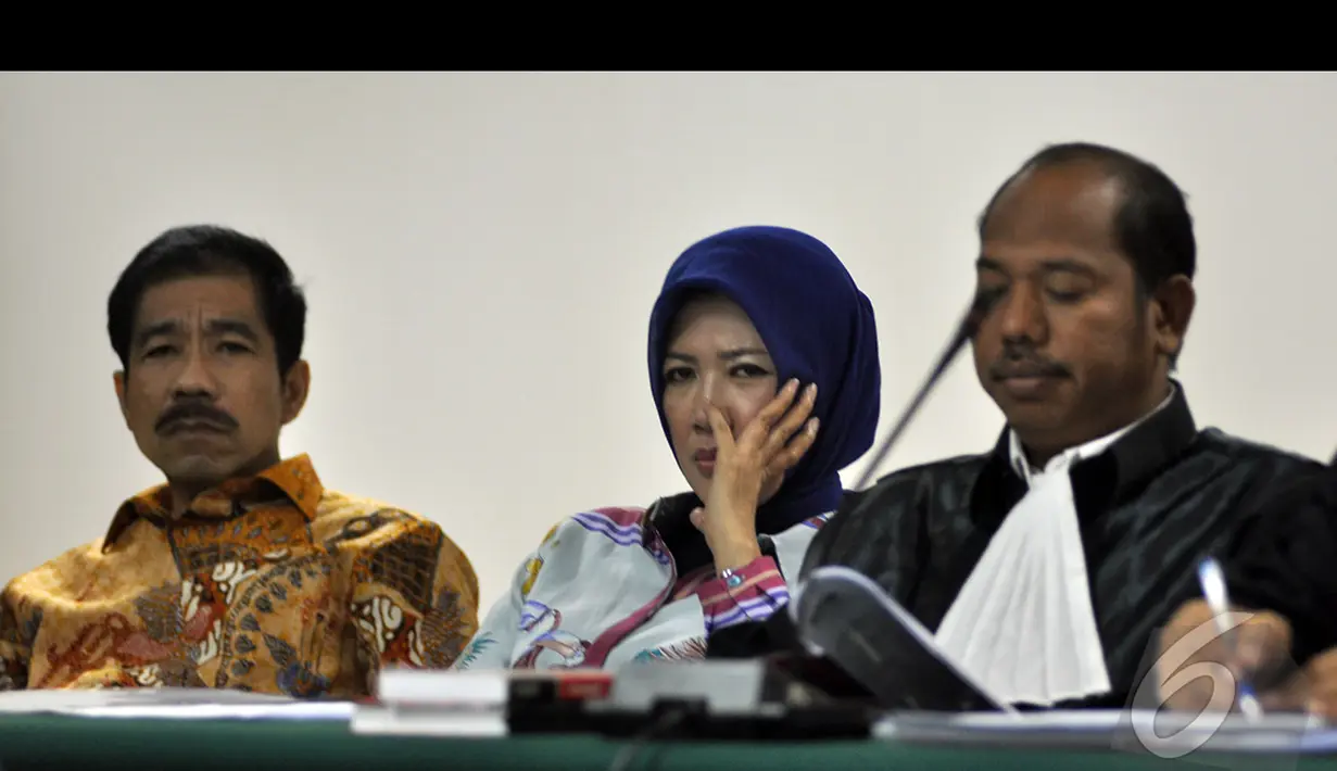 Romi Herton (kiri) dan Istri saat menjalani sidang lanjutan di Pengadilan Tipikor, Jakarta, Kamis (15/1/2015). (Liputan6.com/Miftahul Hayat)