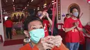 Warga keturunan Tionghoa yang mengenakan masker bersembahyang saat Tahun Baru Imlek di sebuah kuil di kawasan China Town, Jakarta, Jumat (12/2/2021). Tradisi sembahyang yang dilakukan pada perayaan tahun baru Imlek kali ini dibatasi untuk mencegah penyebaran covid-19.  (AP Photo/Tatan Syuflana)