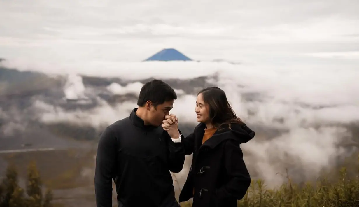<p>Kali ini keduanya memamerkan kemesraan dengan latar pemandangan yang luar biasa. Berpose dengan latar pemandangan alam dan gunung, Gritte tampak mengenakan atasan berwarna oranye yang ditumpuknya dengan jaket tebal hitam, sedangkan Arif mengenakan turtleneck hitam. Foto: Instagram.</p>