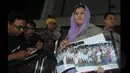 Yenny Wahid menunjukkan foto - foto pada wartawan di depan Gedung Komisi Pemberantasan Korupsi, Jakarta, Kamis (12/2/2015). Yenny Wahid menyampaikan titipan dukungan warga pesantren di jawa barat. (Liputan6.com/Herman Zakharia)